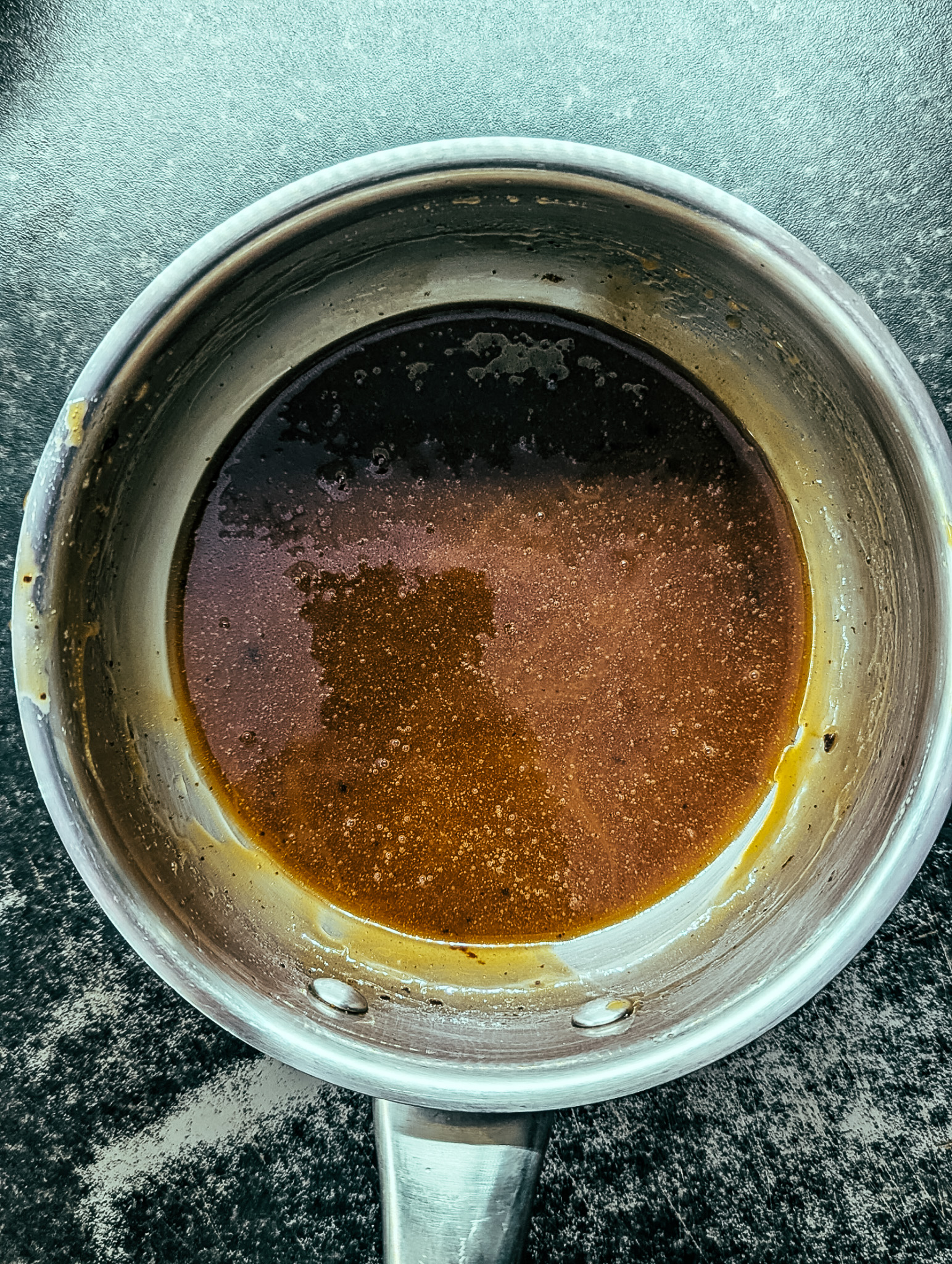 Sweet mocha syrup mixture for nut free granola in a saucepan.