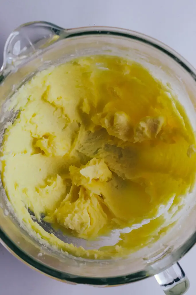Creamed butter and sugar in a glass mixing bowl for vanilla traybake.