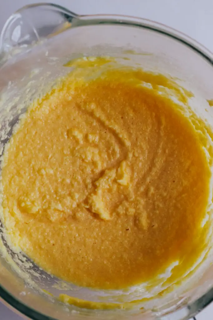 Wet ingredients combined in a mixing bowl forming the base of the vanilla traybake batter.